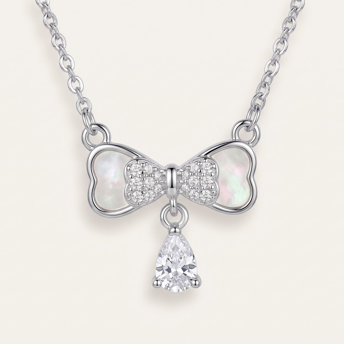 Elegant Silver Bow Necklace with Sparkling Teardrop Pendant