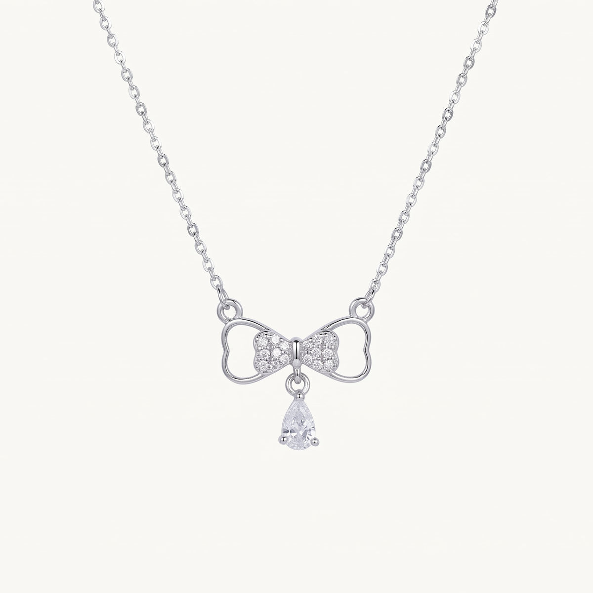 Elegant Silver Bow Necklace with Sparkling Teardrop Pendant