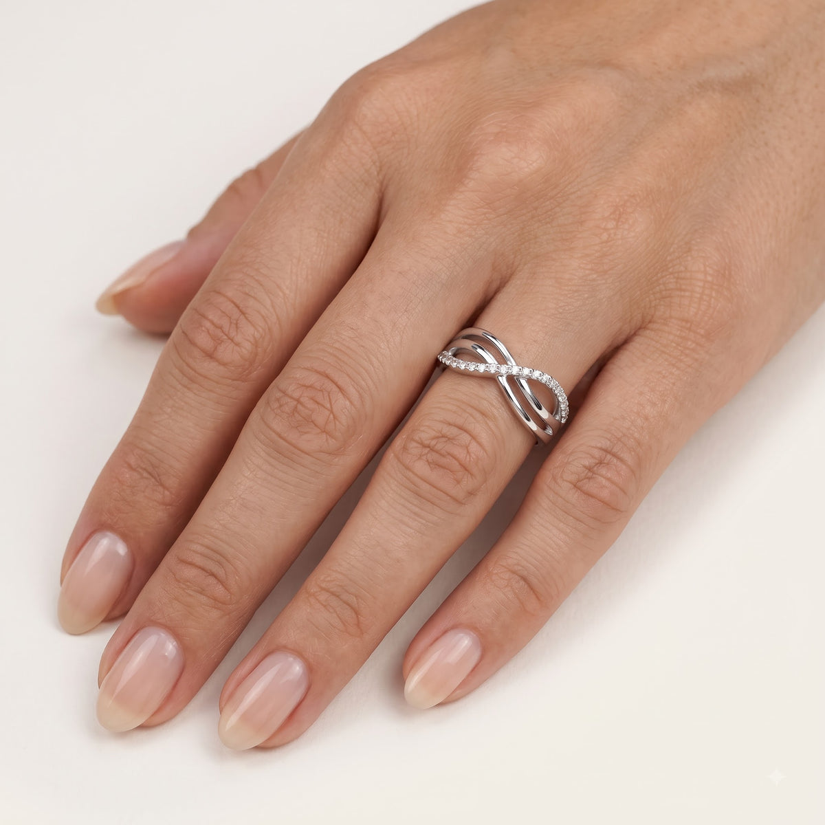 Elegant Silver Interwoven Pavé Ring with Curved Bands and Sparkling Detail