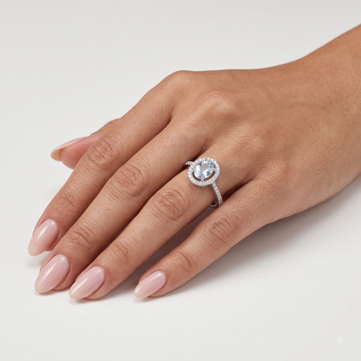 Elegant Blue Oval Gemstone Halo Ring with Sparkling Stone Accents